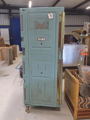 a blue door in the middle of a room filled with furniture