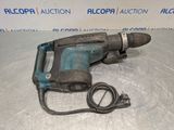 a close up of a drill on a table with a cord