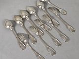 six silver spoons and a fork on a white surface