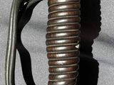 a close up of a sword with a blue handle