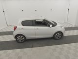 a picture of a small white car parked in a garage