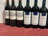 several bottles of wine are lined up on a table