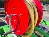 a red and yellow fire hose on top of a green table