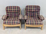 pair of mid century style lounge chairs with plaid upholstered seats