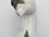 a white and black cat figurine on a white surface