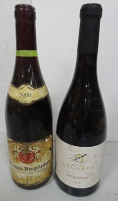 two bottles of wine sitting next to each other on a table