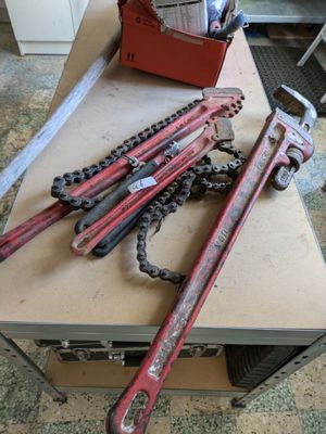 several wrenches are sitting on top of a box on a table