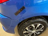 a close up of a blue car with a sticker on it