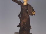 statue of a woman holding a harp on a marble base