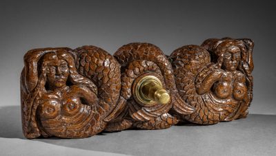 an image of a group of carved wood figures on a gray surface