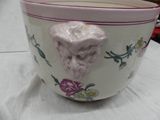 a white bowl with a face on it sitting on a table