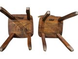 pair of wooden chairs with metal legs on a white background