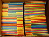a box full of children ' s books stacked on top of each other