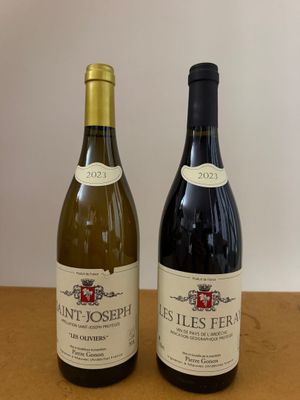 two bottles of wine that are sitting on a table