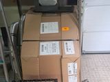 a stack of boxes and a broom on the floor