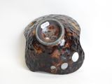 a brown and black object on a white surface