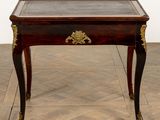 a small table with a glass top on a wooden floor