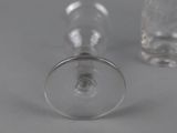 two empty wine glasses sitting next to each other on a table
