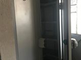 an open door to a room with a chair in it