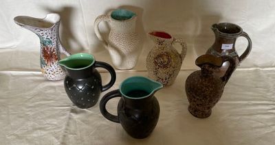five different types of vases sitting on a table