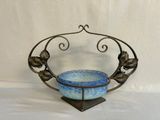 a blue bowl sitting on top of a metal stand