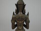 an old bronze statue of a woman holding a sword