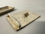 a silver tray and a silver tray on a table