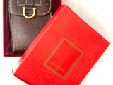 a red box with a black purse inside of it