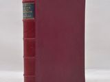a red book sitting on top of a white surface