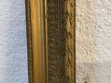 an image of a gold framed mirror against a white wall