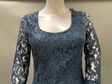 the dress is made of lace and has long sleeves