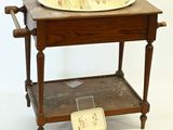 a small wooden table with a bowl on top of it