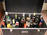 many bottles of alcohol in a metal case on the floor