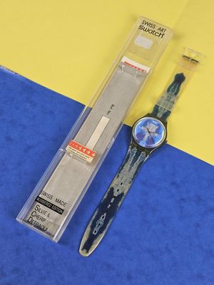 a watch that is laying on a blue and yellow surface