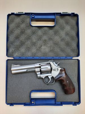 a gun in a case on a table with a blue handle