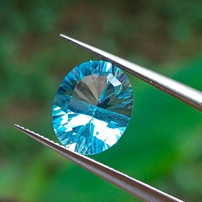 a close up of a blue diamond being held by a pair of pliers