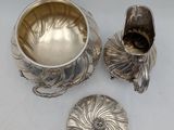 three pieces of silverware including a bowl, spoon and a bowl