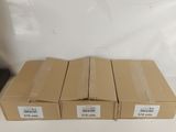 four boxes of brown paper sitting on top of a white table