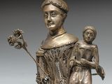 une image représentant une statue en bronze d'une femme tenant un enfant dans ses bras