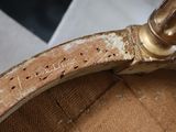 a close up of a chair with a rusted seat