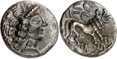 a silver coin with an image of a horse on it