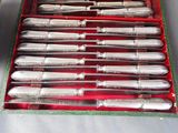 a lot of silverware in a red box on a table