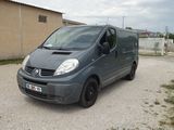 a grey van that is parked in a parking lot