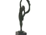 statue of a woman holding a ball on a marble base