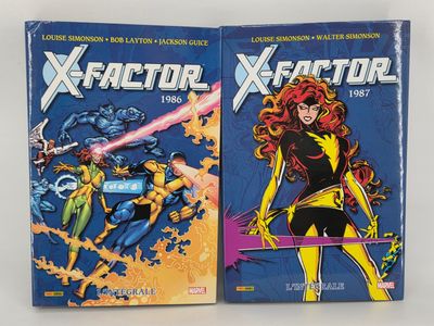 two books of x - factor and x - factor comics are on display