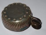 a small metal object that is on a white surface