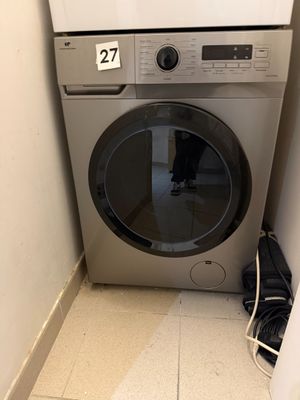 a washer and dryer in the corner of a room