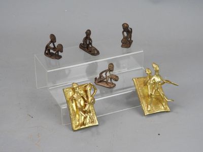 five figurines in a display case on a table