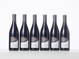 six bottles of red wine lined up in a row