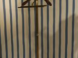 a coat stand with a wooden hanger on it